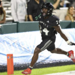 
              Hawaii running back Tylan Hines (24) reacts after making a 69-yard touchdown against Utah State during the fourth quarter of an NCAA college football game, Saturday, Nov. 12, 2022, in Honolulu. (AP Photo/Marco Garcia)
            