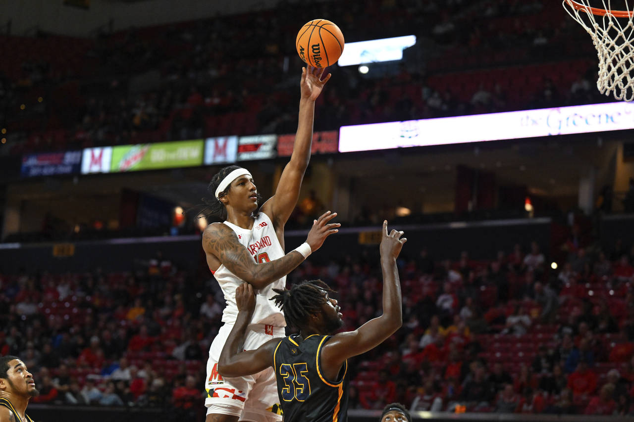 Maryland forward Julian Reese shoots the ball over Coppin State forward Justin Winston (35) during ...