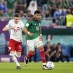 
              Mexico's Alexis Vega, right, and Poland's Sebastian Szymanski, challenge for the ball, during the World Cup group C soccer match between Mexico and Poland, at the Stadium 974 in Doha, Qatar, Tuesday, Nov. 22, 2022. (AP Photo/Aijaz Rahi)
            