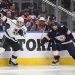 
              Los Angeles Kings' Trevor Moore (12) checks Edmonton Oilers' Brett Kulak (27) during the third period of an NHL hockey game Wednesday, Nov. 16, 2022, in Edmonton, Alberta. (Jason Franson/The Canadian Press via AP)
            
