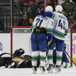 
              Vancouver Canucks left wing Nils Hoglander (21) and defenseman Quinn Hughes (43) celebrate after their team scored against the Vegas Golden Knights during the second period of an NHL hockey game Saturday, Nov. 26, 2022, in Las Vegas. (AP Photo/John Locher)
            
