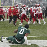 
              Michigan State wide receiver Keon Coleman sits in the end zone as Indiana celebrates the win after the second overtime of an NCAA college football game, Saturday, Nov. 19, 2022, in East Lansing, Mich. (AP Photo/Carlos Osorio)
            