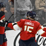 
              Florida Panthers center Sam Reinhart, left, celebrates scoring against the Anaheim Ducks with center Anton Lundell, right, and left wing Ryan Lomberg during the third period of an NHL hockey game in Anaheim, Calif., Sunday, Nov. 6, 2022. (AP Photo/Alex Gallardo)
            