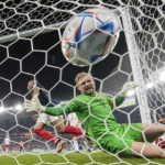 
              France's Kylian Mbappe scores past Denmark's goalkeeper Kasper Schmeichel his side's second goal during the World Cup group D soccer match between France and Denmark, at the Stadium 974 in Doha, Qatar, Saturday, Nov. 26, 2022. (AP Photo/Martin Meissner)
            