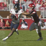 
              Liberty running back Dae Dae Hunter (0) is knocked out of bounds by Arkansas linebacker Chris Paul Jr., right, during the first half of an NCAA college football game Saturday, Nov. 5, 2022, in Fayetteville, Ark. (AP Photo/Michael Woods)
            