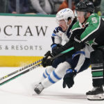 
              Winnipeg Jets center Michael Eyssimont (23) skates with the puck against Dallas Stars defenseman Nils Lundkvist (5) during the second period of an NHL hockey game in Dallas, Friday, Nov. 25, 2022. (AP Photo/LM Otero)
            