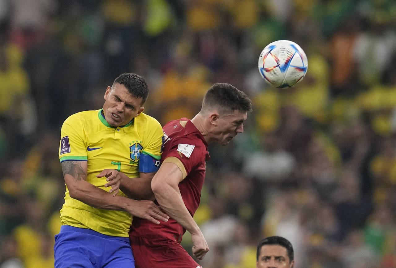 Serbia's Dusan Vlahovic, right, and Brazil's Thiago Silva, go for a header during the World Cup gro...