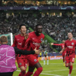 
              Frankfurt's Randal Kolo Muani, centre, celebrates after scoring his side's second goal during a Champions League group D soccer match between Sporting CP and Frankfurt at the Alvalade stadium in Lisbon, Tuesday, Nov. 1, 2022. (AP Photo/Armando Franca)
            