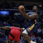 
              New Orleans Pelicans forward Zion Williamson (1) drives to the basket past Toronto Raptors forward O.G. Anunoby in the first half of an NBA basketball game in New Orleans, Wednesday, Nov. 30, 2022. (AP Photo/Gerald Herbert)
            