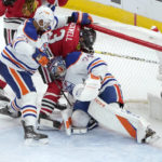 
              Edmonton Oilers goaltender Stuart Skinner (74) holds his ground as Chicago Blackhawks' Colin Blackwell enters the goal crease and Darnell Nurse defends during the second period of an NHL hockey game Wednesday, Nov. 30, 2022, in Chicago. (AP Photo/Charles Rex Arbogast)
            