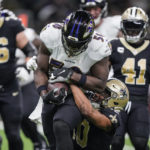 
              Baltimore Ravens linebacker Justin Houston (50) runs with his interception as he is tackled by New Orleans Saints wide receiver Tre'Quan Smith (10) in the second half of an NFL football game in New Orleans, Monday, Nov. 7, 2022. (AP Photo/Gerald Herbert)
            