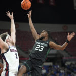 
              Portland State guard Jorell Saterfield (23) shoots as Gonzaga forward Drew Timme (2) defends during the first half of an NCAA college basketball game in the Phil Knight Legacy tournament Thursday, Nov. 24, 2022, in Portland, Ore. (AP Photo/Rick Bowmer)
            