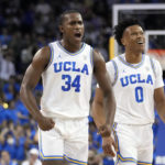 
              UCLA guard David Singleton (34) celebrates with guard Jaylen Clark (0) after making a three-point basket during the first half of an NCAA college basketball game against Sacramento State Monday, Nov. 7, 2022, in Los Angeles. (AP Photo/Marcio Jose Sanchez)
            