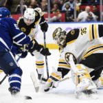 
              Toronto Maple Leafs forward Michael Bunting (58) and Boston Bruins defenseman Connor Clifton (75) jostle for position while Boston Bruins goaltender Linus Ullmark (35) defends the net during the second period of an NHL hockey game, Saturday, Nov. 5, 2022 in Toronto. (Christopher Katsarov/The Canadian Press via AP)
            
