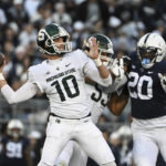 
              Michigan State quarterback Payton Thorne (10) looks to throw a pass while pressured by Penn State defensive end Adisa Isaac (20) during the first half of an NCAA college football game, Saturday, Nov. 26, 2022, in State College, Pa. (AP Photo/Barry Reeger)
            