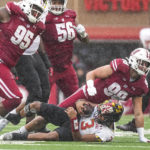 
              Wisconsin defensive end Isaiah Mullens (99) sacks Maryland quarterback Taulia Tagovailoa (3) during the first half of an NCAA college football game Saturday, Nov. 5, 2022, in Madison, Wis. (AP Photo/Andy Manis)
            
