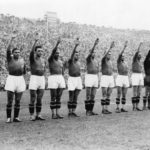 
              FILE - The Italian soccer team perform the fascist salute in Colombes Stadium, Paris, before the start of the World Cup final soccer match against Hungary on June 19, 1938. Earlier in the tournament that was taking place amid the drumbeat of war, the team caused consternation by wearing black shirts in a match. (AP Photo/File)
            