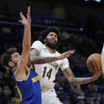 
              New Orleans Pelicans forward Brandon Ingram (14) tries to drives to the basket against Golden State Warriors guard Ty Jerome in the first half of an NBA basketball game in New Orleans, Monday, Nov. 21, 2022. (AP Photo/Gerald Herbert)
            