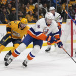 
              New York Islanders' Noah Dobson (8) moves the puck ahead of Nashville Predators' Cole Smith (36) in the second period of an NHL hockey game Thursday, Nov. 17, 2022, in Nashville, Tenn. (AP Photo/Mark Humphrey)
            