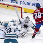 
              The puck deflects off the crossbar behind San Jose Sharks goaltender Kaapo Kahkonen on a shot by Montreal Canadiens' Christian Dvorak during the second period of an NHL hockey game Tuesday, Nov. 29, 2022, in Montreal. (Paul Chiasson/The Canadian Press via AP)
            