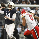 
              Penn State quarterback Sean Clifford (14) throws a pass while being pressured by Maryland defensive lineman Greg China-Rose (0) during the first half of an NCAA college football game, Saturday, Nov. 12, 2022, in State College, Pa. (AP Photo/Barry Reeger)
            