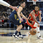 
              New Orleans Pelicans guard CJ McCollum (3) passes the ball around Indiana Pacers guard T.J. McConnell (9) during the first quarter of an NBA Basketball game, Monday, Nov. 7, 2022, in Indianapolis, Ind. (AP Photo/Marc Lebryk)
            
