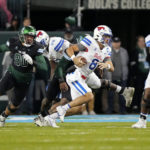 
              Southern Methodist quarterback Tanner Mordecai (8) scrambles under pressure from Tulane linebacker Devean Deal (90) during the first half of an NCAA college football game in New Orleans, Thursday, Nov. 17, 2022. (AP Photo/Gerald Herbert)
            