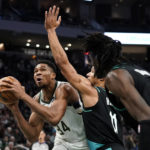 
              Milwaukee Bucks' Giannis Antetokounmpo, left, drives to the basket against Portland Trail Blazers' Josh Hart, center, and Jerami Grant, right, during the second half of an NBA basketball game Monday, Nov. 21, 2022, in Milwaukee. (AP Photo/Aaron Gash)
            