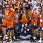 
              Illinois forward Coleman Hawkins (33) and guards Jayden Epps, center left, and Sencire Harris celebrate during the second half of the team's NCAA college basketball game against UCLA on Friday, Nov. 18, 2022, in Las Vegas. (AP Photo/Chase Stevens)
            