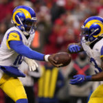 
              Los Angeles Rams quarterback Bryce Perkins, left, hands the ball off to running back Cam Akers (3) during the first half of an NFL football game against the Kansas City Chiefs Sunday, Nov. 27, 2022, in Kansas City, Mo. (AP Photo/Charlie Riedel)
            