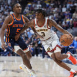 
              Denver Nuggets guard Bones Hyland, right, drives past New York Knicks guard Immanuel Quickley during the second half of an NBA basketball game Wednesday, Nov. 16, 2022, in Denver. (AP Photo/David Zalubowski)
            