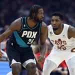 
              Portland Trail Blazers forward Justise Winslow (26) plays against Cleveland Cavaliers guard Donovan Mitchell (45) during the first half of an NBA basketball game, Wednesday, Nov. 23, 2022, in Cleveland. (AP Photo/Ron Schwane)
            