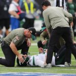 
              A trainer checks on New York Jets quarterback Zach Wilson after he suffered a knee injury during the first half of an NFL football game against the Buffalo Bills, Sunday, Nov. 6, 2022, in East Rutherford, N.J. (AP Photo/Noah K. Murray)
            