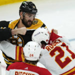
              Boston Bruins left wing Nick Foligno, left, fights Calgary Flames center Kevin Rooney (21) during the third period of an NHL hockey game, Thursday, Nov. 10, 2022, in Boston. (AP Photo/Charles Krupa)
            