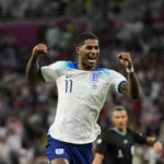 
              England's Marcus Rashford celebrates after scoring his side's third goal during the World Cup group B soccer match between England and Wales, at the Ahmad Bin Ali Stadium in Al Rayyan , Qatar, Tuesday, Nov. 29, 2022. (AP Photo/Frank Augstein)
            