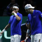 
              Italy's Simone Bolelli, right, speaks to Fabio Fognini during the doubles match against Tommy Paul and Jack Sock of the USA in a Davis Cup quarter-final tennis match between Italy and USA in Malaga, Spain, Thursday, Nov. 24, 2022. (AP Photo/Joan Monfort)
            