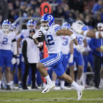 
              BYU wide receiver Puka Nacua (12) runs the ball for a touchdown against Stanford during the second half of an NCAA college football game in Stanford, Calif., Saturday, Nov. 26, 2022. (AP Photo/Godofredo A. Vásquez)
            