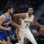 
              New Orleans Pelicans guard CJ McCollum (3) drives against Golden State Warriors guard Ty Jerome in the first half of an NBA basketball game in New Orleans, Monday, Nov. 21, 2022. (AP Photo/Gerald Herbert)
            