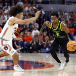 
              South Florida guard Tyler Harris (2) dribbles the ball as Auburn guard Tre Donaldson (3) defends during the first half of an NCAA college basketball game Friday, Nov. 11, 2022, in Auburn, Ala. (AP Photo/Butch Dill)
            