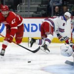 
              Detroit Red Wings center Michael Rasmussen (27) takes a shot on New York Rangers goaltender Igor Shesterkin (31) after getting past defenseman Jacob Trouba (8) during the second period of an NHL hockey game Thursday, Nov. 10, 2022, in Detroit. (AP Photo/Duane Burleson)
            