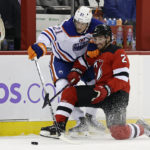 
              New Jersey Devils defenseman Brendan Smith (2) battles for the puck with Edmonton Oilers center Klim Kostin during the first period of an NHL hockey game Monday, Nov. 21, 2022, in Newark, N.J. (AP Photo/Adam Hunger)
            