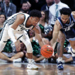 
              Michigan State's Jaden Akins, left, steals the ball from Villanova's Caleb Daniels during the second half of an NCAA college basketball game Friday, Nov. 18, 2022, in East Lansing, Mich. Michigan State won 73-71. (AP Photo/Al Goldis)
            