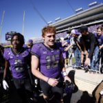 
              TCU quarterback Max Duggan (15) and wide receiver Blair Conwright (0) celebrate with fans following the team's 34-24 win over Texas Tech in an NCAA college football game Saturday, Nov. 5, 2022, in Fort Worth, Texas. (AP Photo/Ron Jenkins)
            