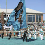 
              FILE - The Coastal Carolina cheerleaders lead the team onto the field before an NCAA college football game against Georgia State on Nov. 13, 2021, in Conway, S.C. What looked like a week of opportunity for No. 23 Coastal Carolina quickly became one of grief and unconditional support for the University of Virginia football team the Chants were supposed to play on Saturday, Nov. 19, 2022. That game was called off Wednesday, Nov. 16, as Virginia continued grieving their three football players killed by a former member of the Cavaliers last Sunday night, Nov. 13. (AP Photo/Artie Walker, Jr., File)
            