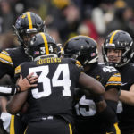 
              Iowa linebacker Jay Higgins (34) celebrates with teammates after recovering a blocked punt during the first half of an NCAA college football game against Wisconsin, Saturday, Nov. 12, 2022, in Iowa City, Iowa. (AP Photo/Charlie Neibergall)
            