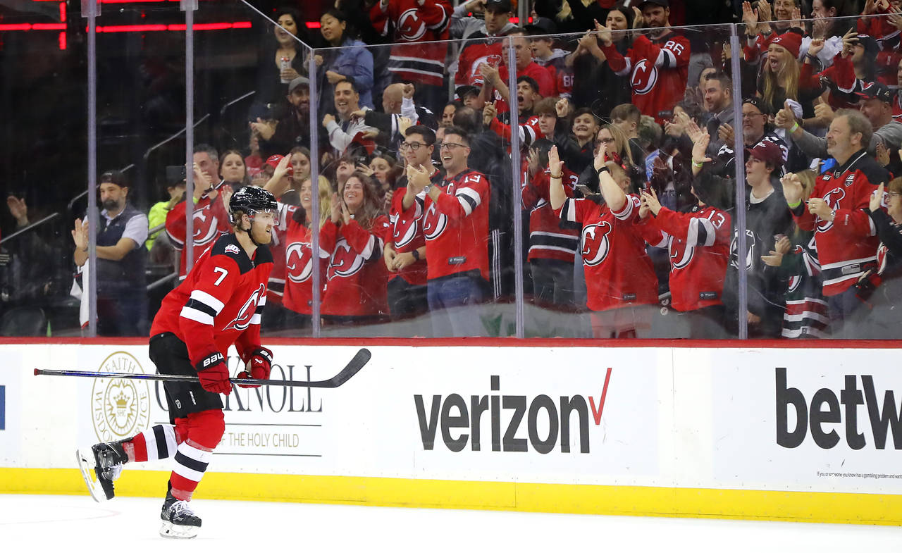 New Jersey Devils defenseman Dougie Hamilton (7) goes to the banch after scoring a goal against the...
