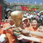 
              FILE - Chinese children pose with a replica of the World Cup trophy on the Great Wall of China at Jinshanling during an event to show their support for the Chinese national soccer team Saturday, May 25, 2002. China is missing out on the World Cup again despite spending millions — probably billions — to develop the game, a reported priority of Xi Jinping, the all-powerful general secretary of the Chinese Communist Party.  (AP Photo/str, File)
            