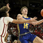 
              South Dakota State guard Tanner Te Slaa (15) tries too drive past Arkansas guard Anthony Black (0) during the first half of an NCAA college basketball game Wednesday, Nov. 16, 2022, in Fayetteville, Ark. (AP Photo/Michael Woods)
            