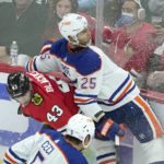 
              Chicago Blackhawks' Colin Blackwell (43) checks Edmonton Oilers' Darnell Nurse against the boards during the second period of an NHL hockey game Wednesday, Nov. 30, 2022, in Chicago. (AP Photo/Charles Rex Arbogast)
            