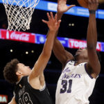 
              Los Angeles Lakers center Thomas Bryant, right, shoots against San Antonio Spurs forward Isaiah Roby during the first half of an NBA basketball game Sunday, Nov. 20, 2022 in Los Angeles. (AP Photo/Ringo H.W. Chiu)
            